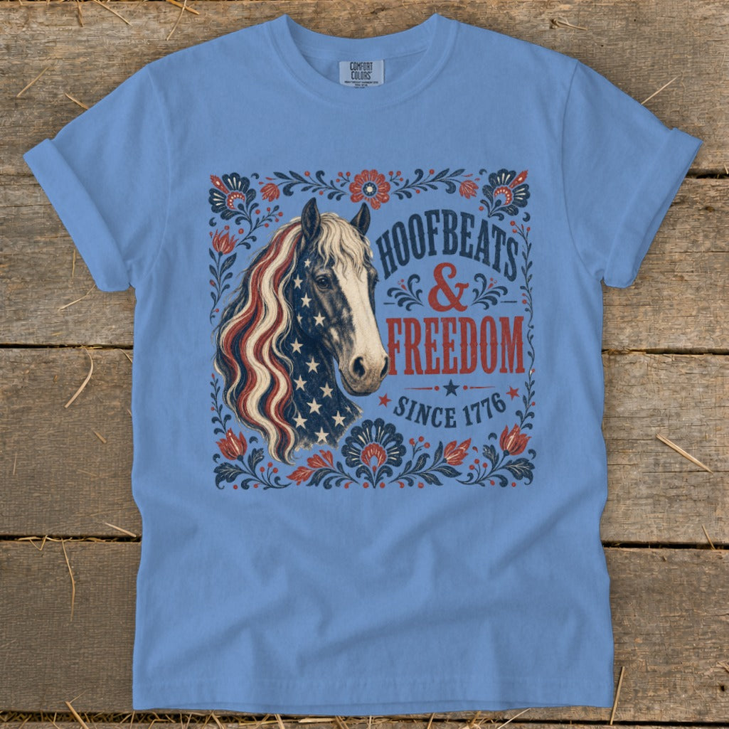 Blue t-shirt with a horse head in patriotic colors and "Hoofbeats & Freedom since 1776" text.