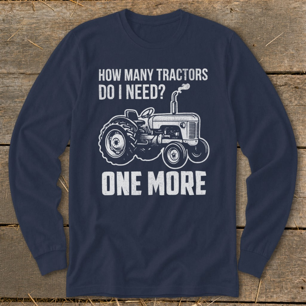 Navy long-sleeve shirt with a graphic of a tractor and text "HOW MANY TRACTORS DO I NEED? ONE MORE."