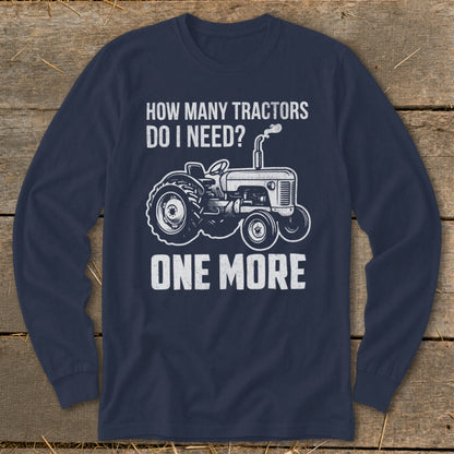 Navy long-sleeve shirt with a graphic of a tractor and text "HOW MANY TRACTORS DO I NEED? ONE MORE."
