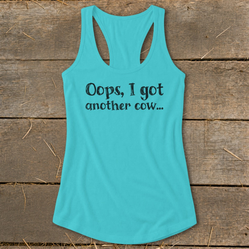Turquoise tank top with black text that reads "Oops, I got another cow...".