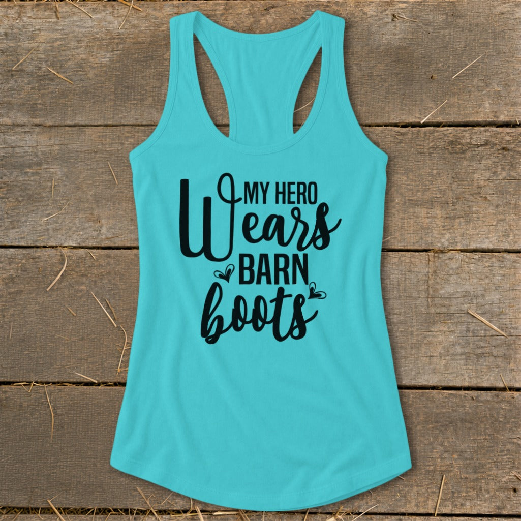 Turquoise racerback tank top with "My Hero Wears Barn Boots" graphic text.