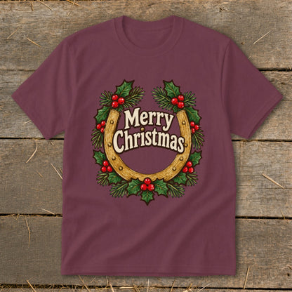Maroon t-shirt with a horseshoe and holly wreath graphic saying "Merry Christmas".