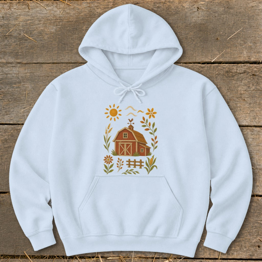 Light blue hoodie with a rustic barn, sun, and floral design graphic.