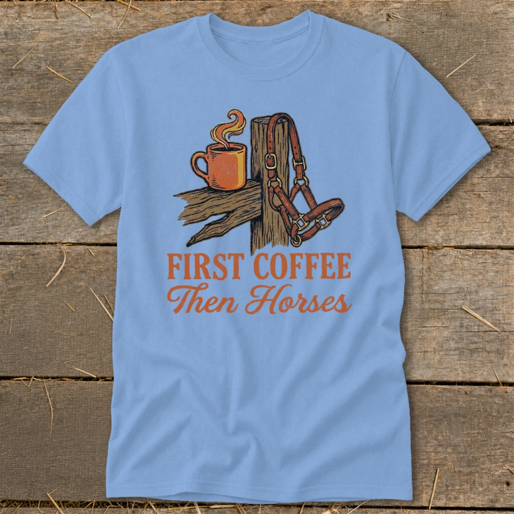 Light blue t-shirt with illustration of coffee and horse halter, reads "First Coffee Then Horses".