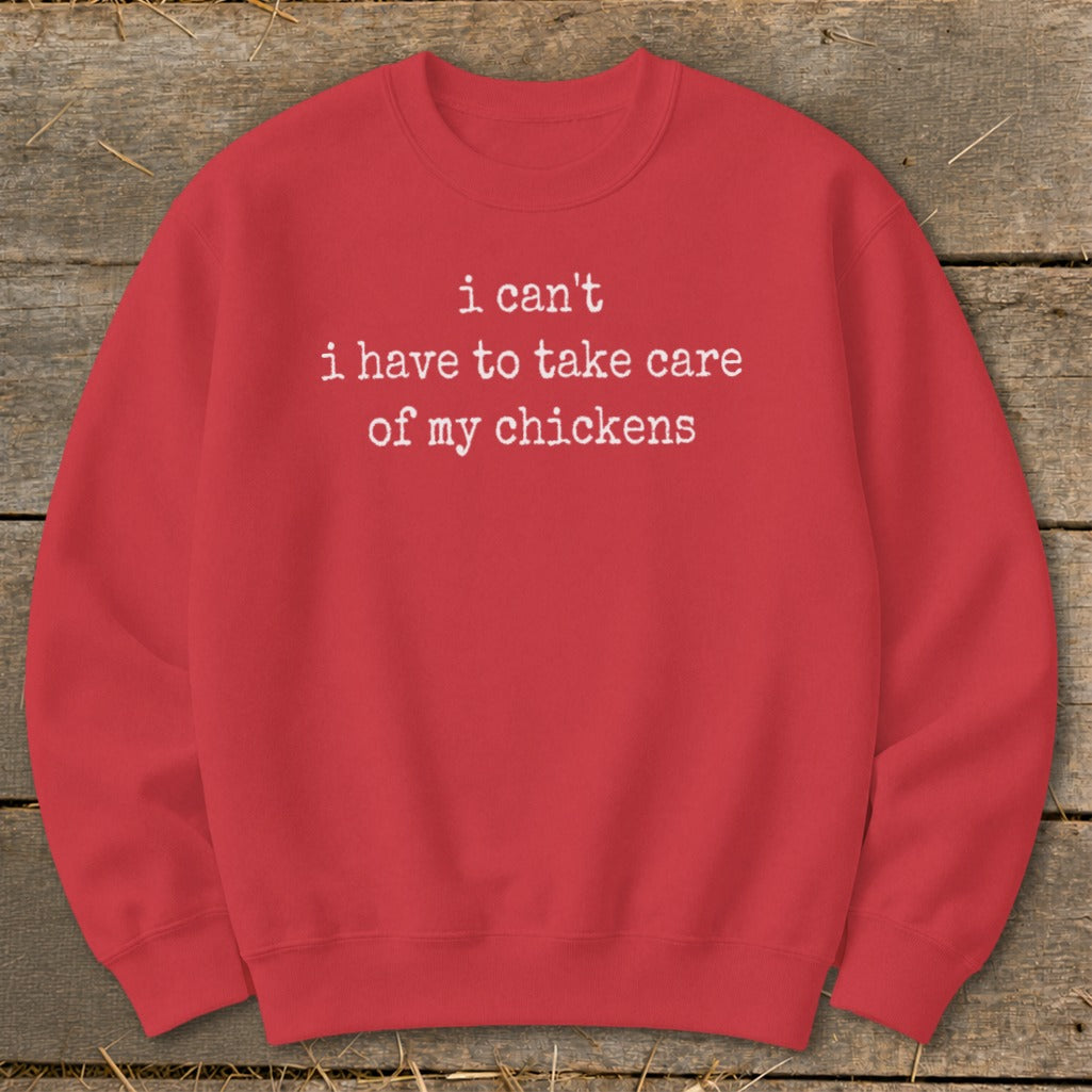 Red sweatshirt with white text that reads "i can't i have to take care of my chickens".