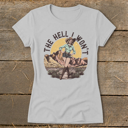 Cowgirl with text "The Hell I Won't" in a desert landscape graphic.