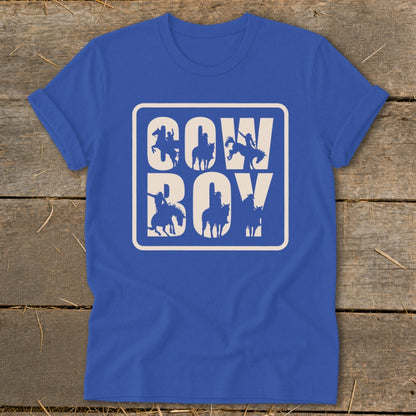 Blue t-shirt with white "COW BOY" text and cowboy silhouettes within a rounded rectangle.