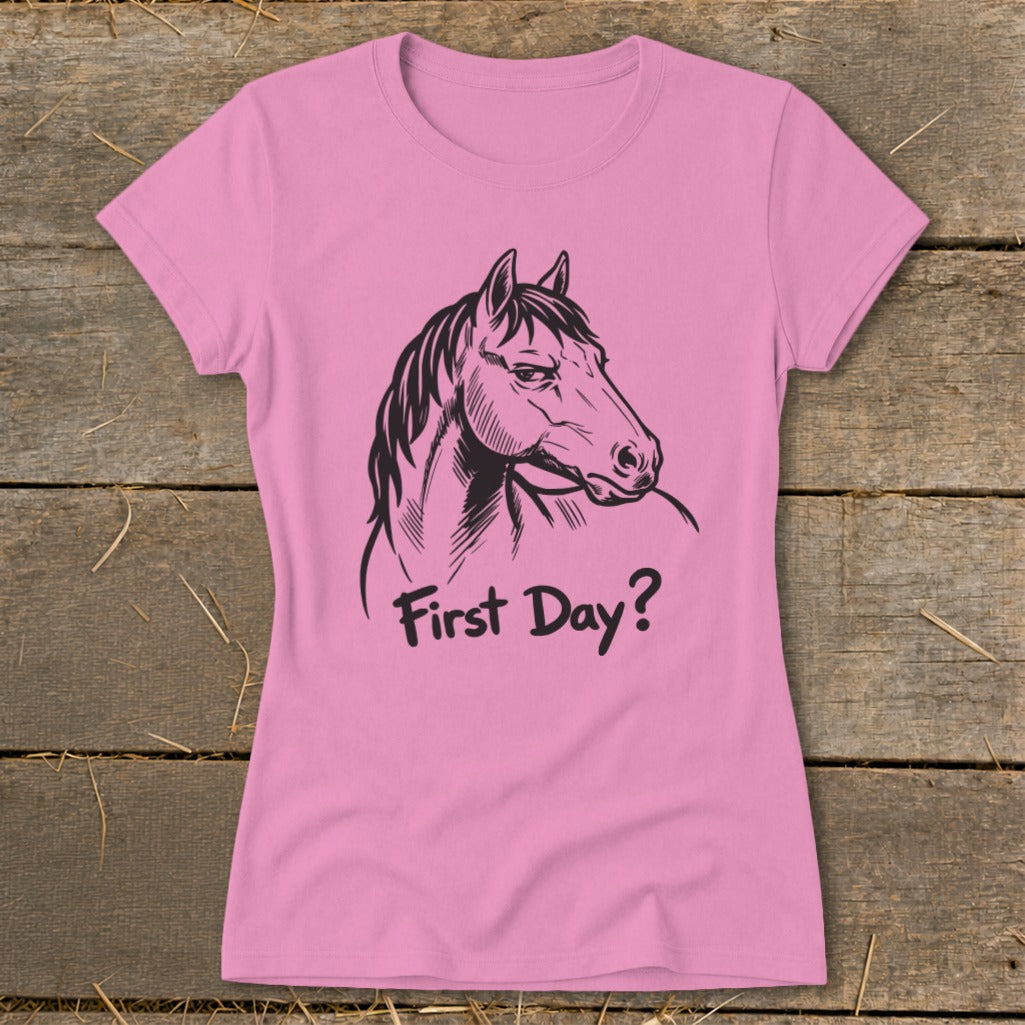 Pink t-shirt with a black line drawing of a horse's head and the text "First Day?"