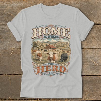 T-shirt graphic says "HOME IS WHERE THE HERD IS" with cattle and farm scene.