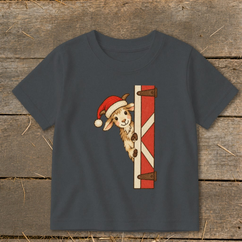 Dark gray t-shirt with a cartoon goat wearing a Santa hat peeking from behind a barn door.