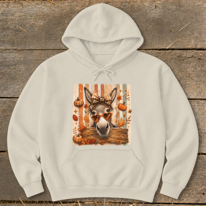 Donkey wearing heart sunglasses and bow tie with fall leaves and pumpkins.