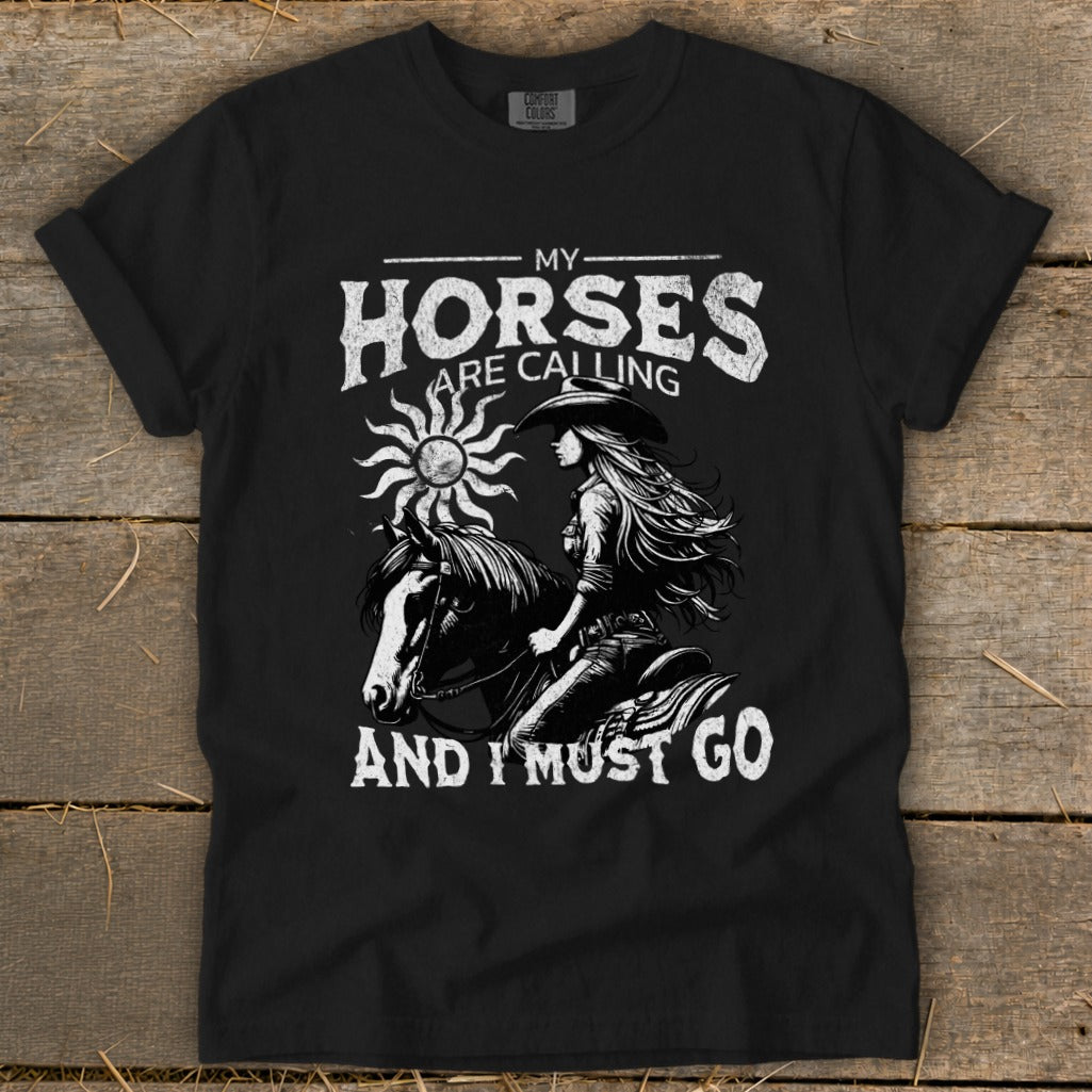 Black t-shirt with graphic: "My Horses Are Calling And I Must Go" and a rider on a horse.
