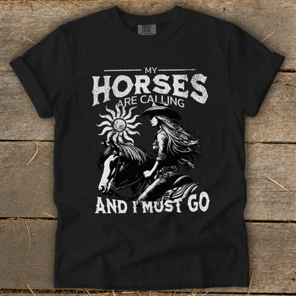Black t-shirt with graphic: "My Horses Are Calling And I Must Go" and a rider on a horse.