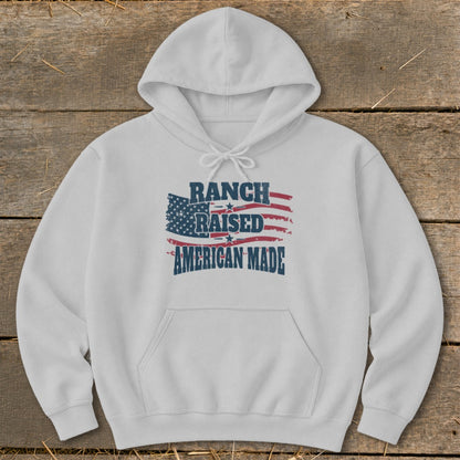 White hoodie with "Ranch Raised American Made" text and American flag graphic.