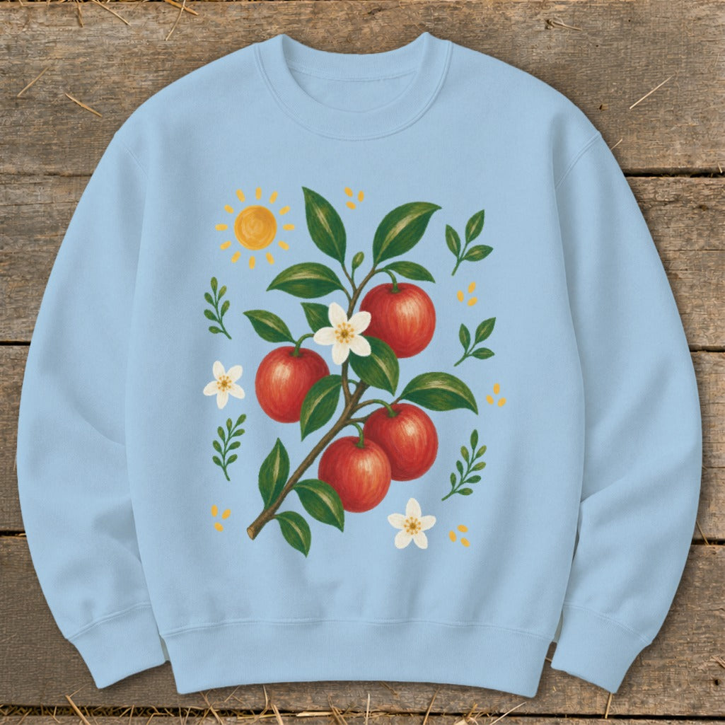 Light blue crewneck sweatshirt with a watercolor illustration of red apples on a branch.