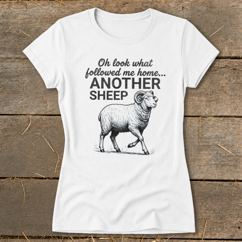 White t-shirt with text "Oh look what followed me home... ANOTHER SHEEP" and a ram illustration.