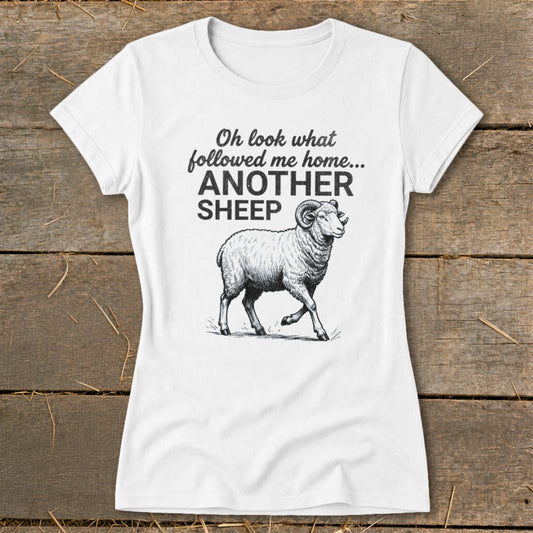 White t-shirt with text "Oh look what followed me home... ANOTHER SHEEP" and a ram illustration.