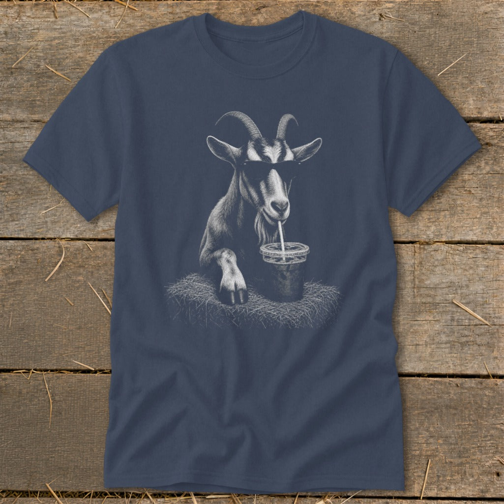 Goat wearing sunglasses drinks from a cup with a straw on a t-shirt.