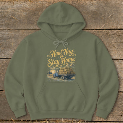 Olive green hoodie with "Haul Hay or Stay Home" text and truck full of hay graphic.
