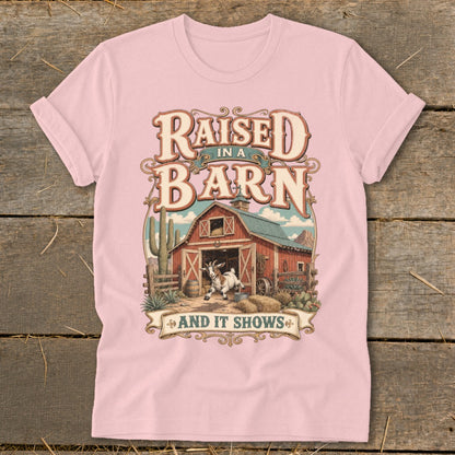 T-shirt with text "Raised in a Barn and it Shows" and barn graphic.