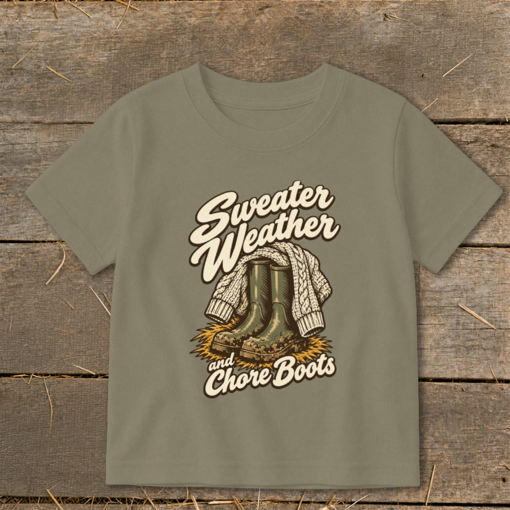 "Sweater Weather and Chore Boots" graphic on a taupe t-shirt.