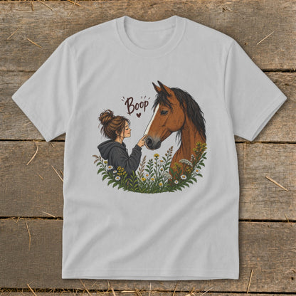 Girl gently booping horse nose surrounded by flowers, with "Boop" text.