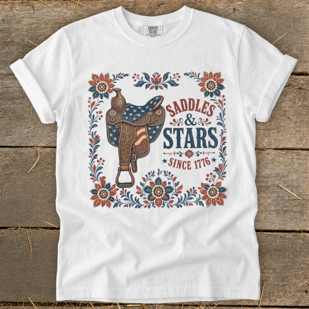 White t-shirt with a vintage saddle and "SADDLES & STARS SINCE 1776" graphic.