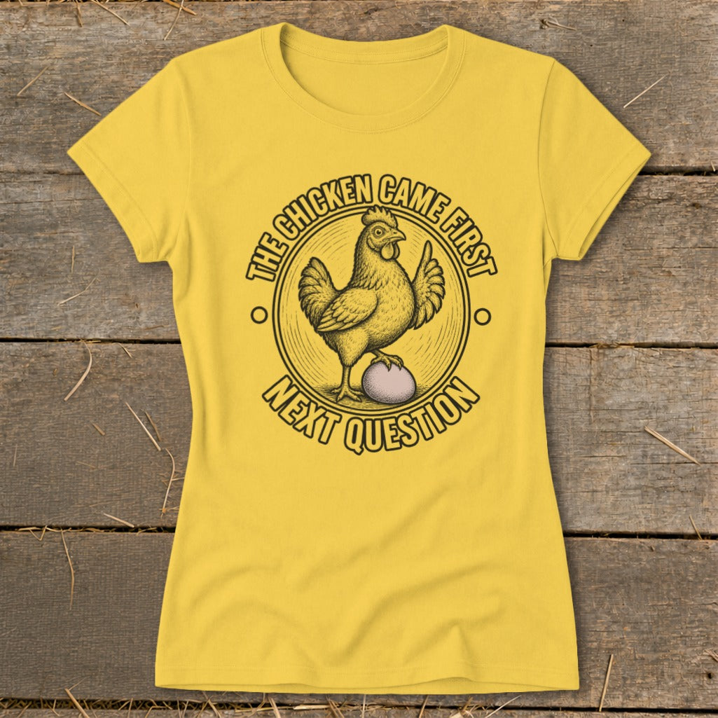 Yellow t-shirt with a chicken on an egg, text reads "The chicken came first. Next question."