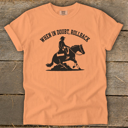 Orange t-shirt with "When in Doubt, Rollback" text and cowboy on horseback graphic.