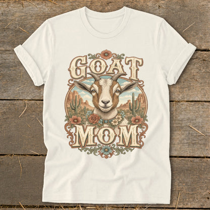 Goat Mom graphic on a cream t-shirt with desert and cactus background.
