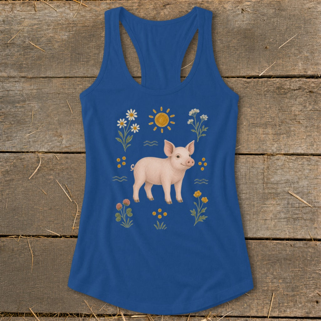Blue tank top with a pig, sun, and wildflowers illustration.