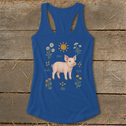 Blue tank top with a pig, sun, and wildflowers illustration.