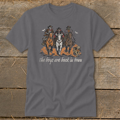 Three skeletal figures on horseback with a dog, text reads "The boys are back in town."