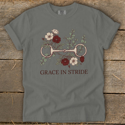 Gray t-shirt with horse bit and flowers design, reads "GRACE IN STRIDE."