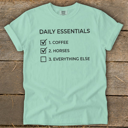 Mint t-shirt with black text reading "Daily Essentials: 1. Coffee, 2. Horses, 3. Everything Else".