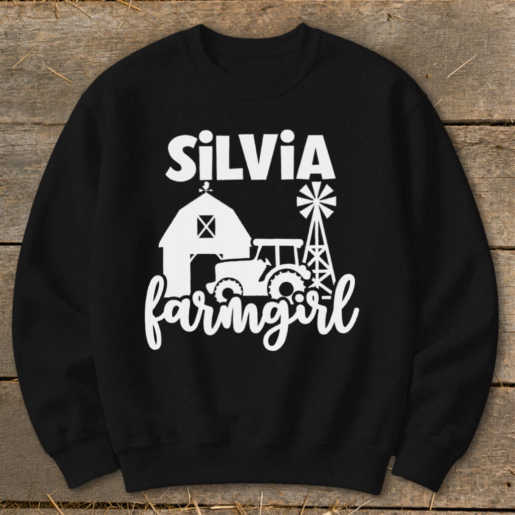 Black sweatshirt with white text and graphics of a barn, tractor, and windmill.