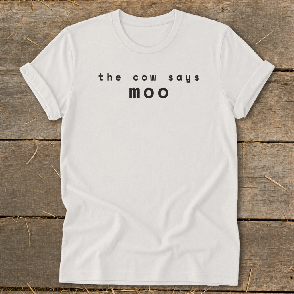 White t-shirt with black text that reads "the cow says moo".