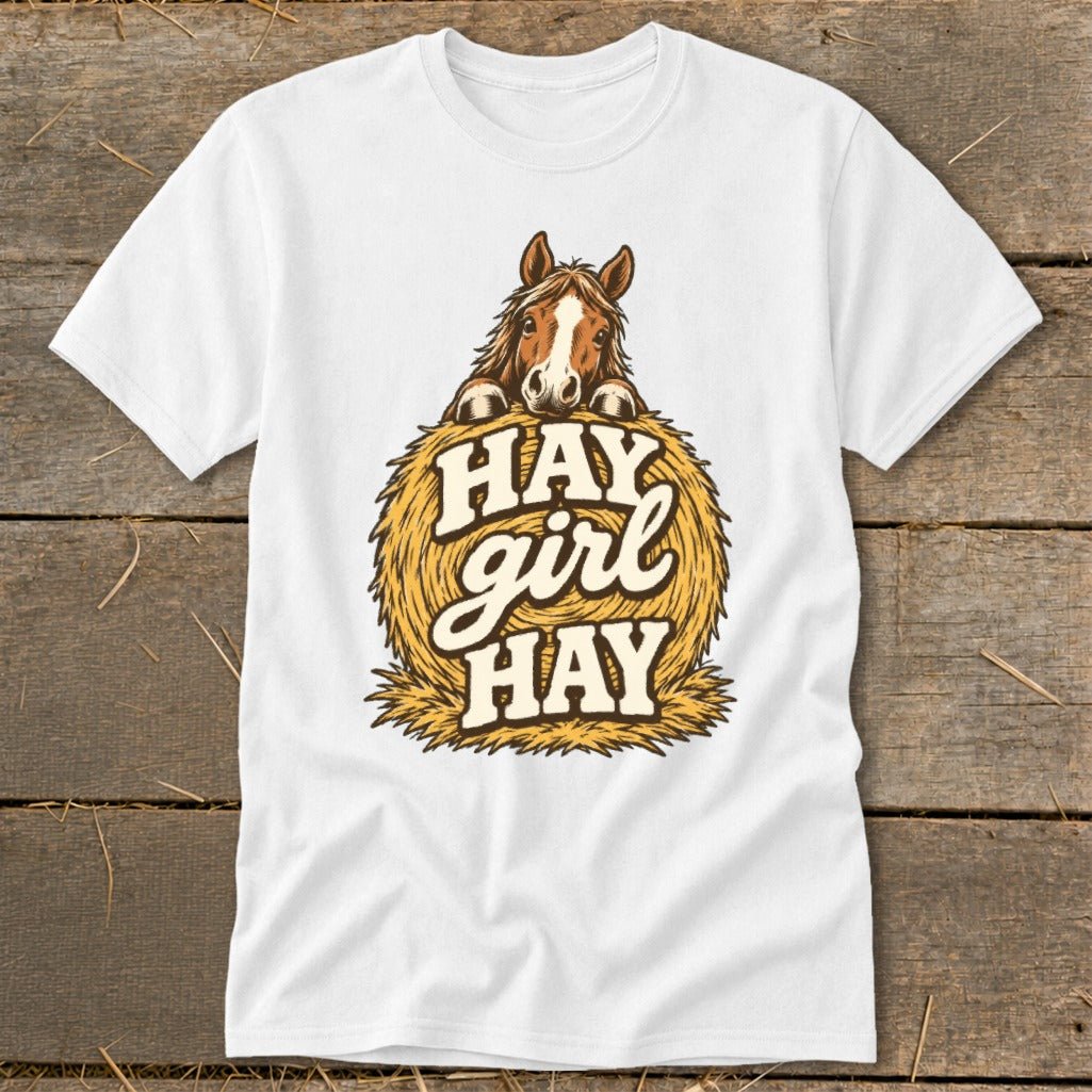 White t-shirt with a horse peeking over a bale of hay, text reads "HAY girl HAY".