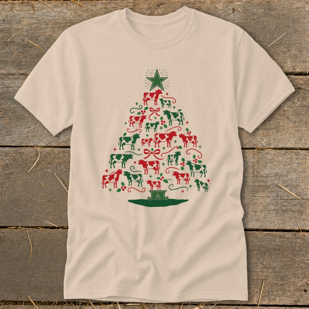 Tan t-shirt with a Christmas tree design made of red and green cows.