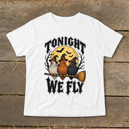 Three chickens wear witch hats and ride a broomstick under a full moon with text "TONIGHT WE FLY".