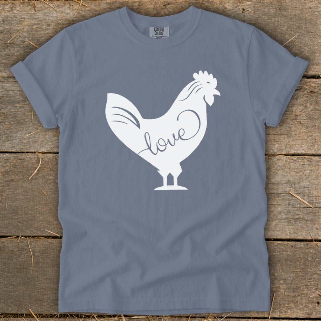 White rooster silhouette with the word "love" inscribed on its body, on a slate blue t-shirt.