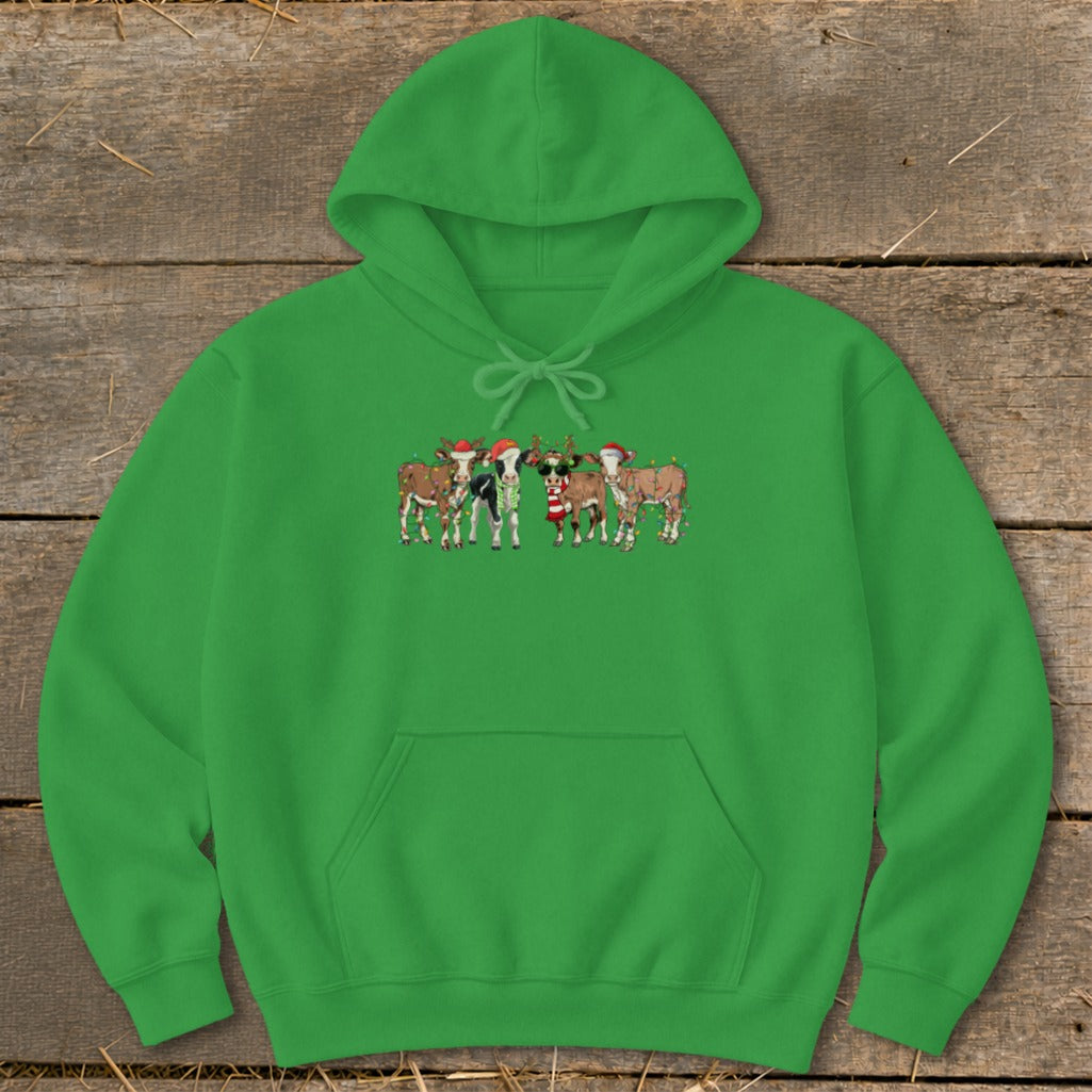 Green hoodie with a Christmas-themed cartoon of cows wearing Santa hats and string lights.