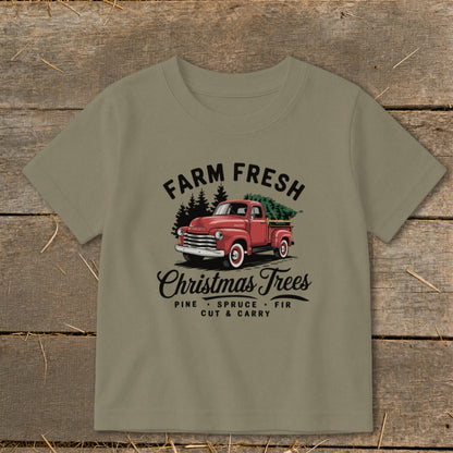 T-shirt graphic with red truck carrying Christmas trees and text "Farm Fresh Christmas Trees".