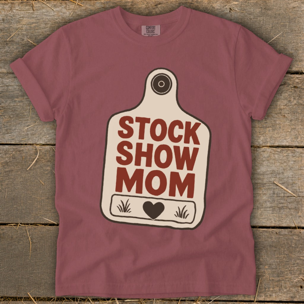 Maroon t-shirt with "Stock Show Mom" text on a tag graphic.