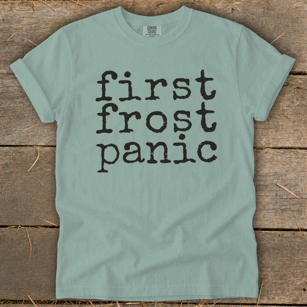 Light blue t-shirt with black text "first frost panic" in typewriter font.