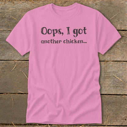 Pink t-shirt with black text that reads "Oops, I got another chicken..."