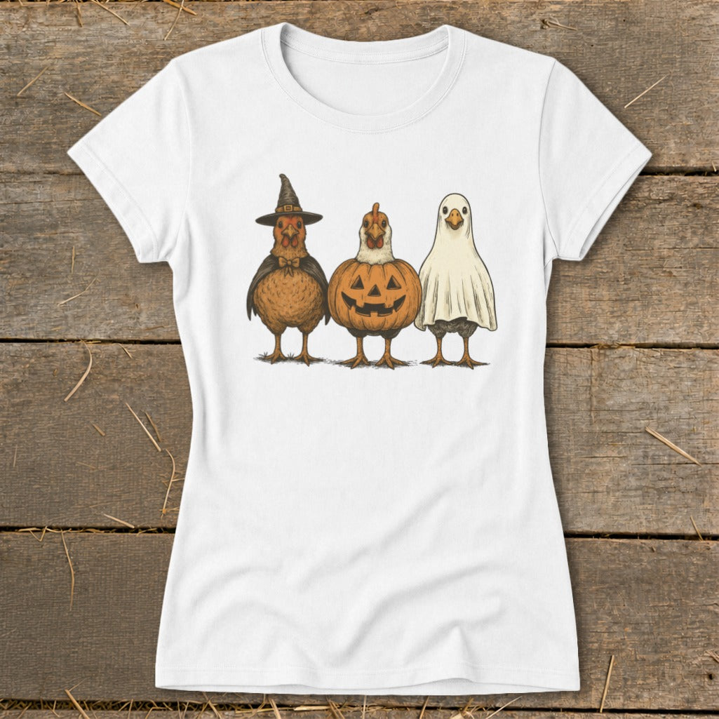 Three chickens dressed as Halloween characters: witch, pumpkin, and ghost.