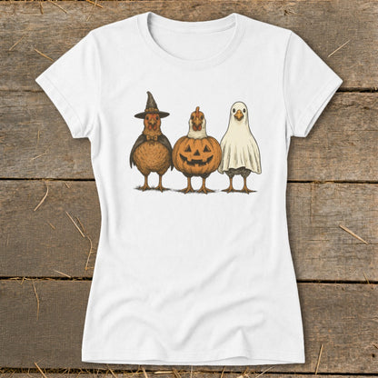 Three chickens dressed as Halloween characters: witch, pumpkin, and ghost.