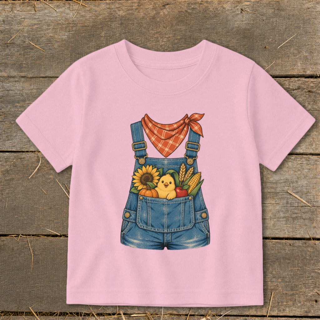 Pink t-shirt with denim overalls graphic featuring a chick, sunflower, pumpkin, corn, and apple.