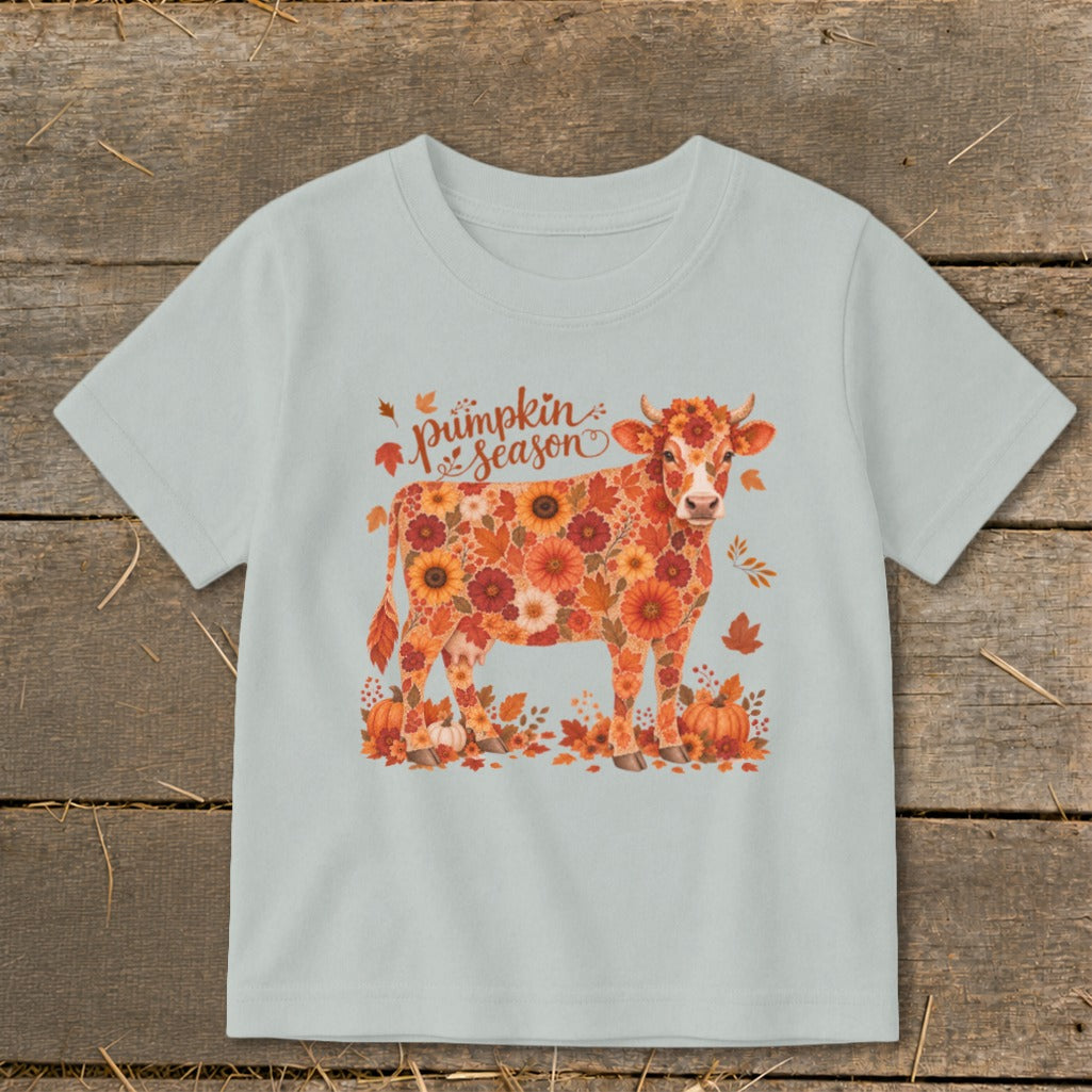 Light blue t-shirt with cow made of pumpkins and autumn flowers, saying "pumpkin season".